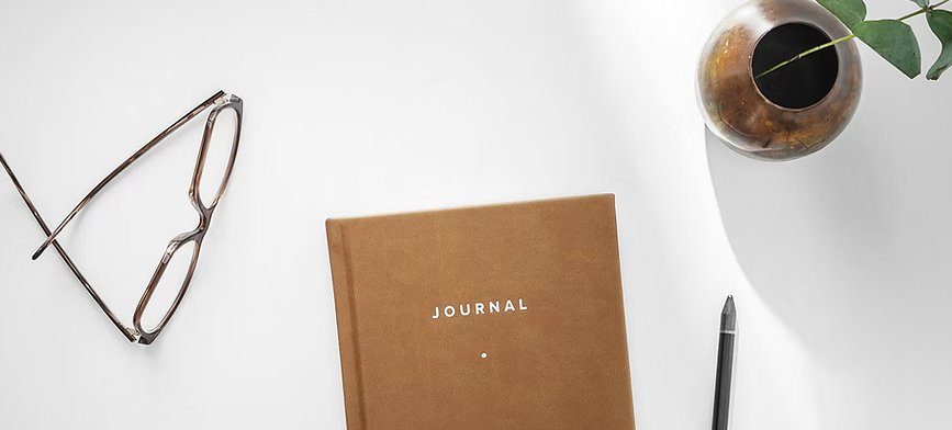 Journal on a desk for self-guided reflection